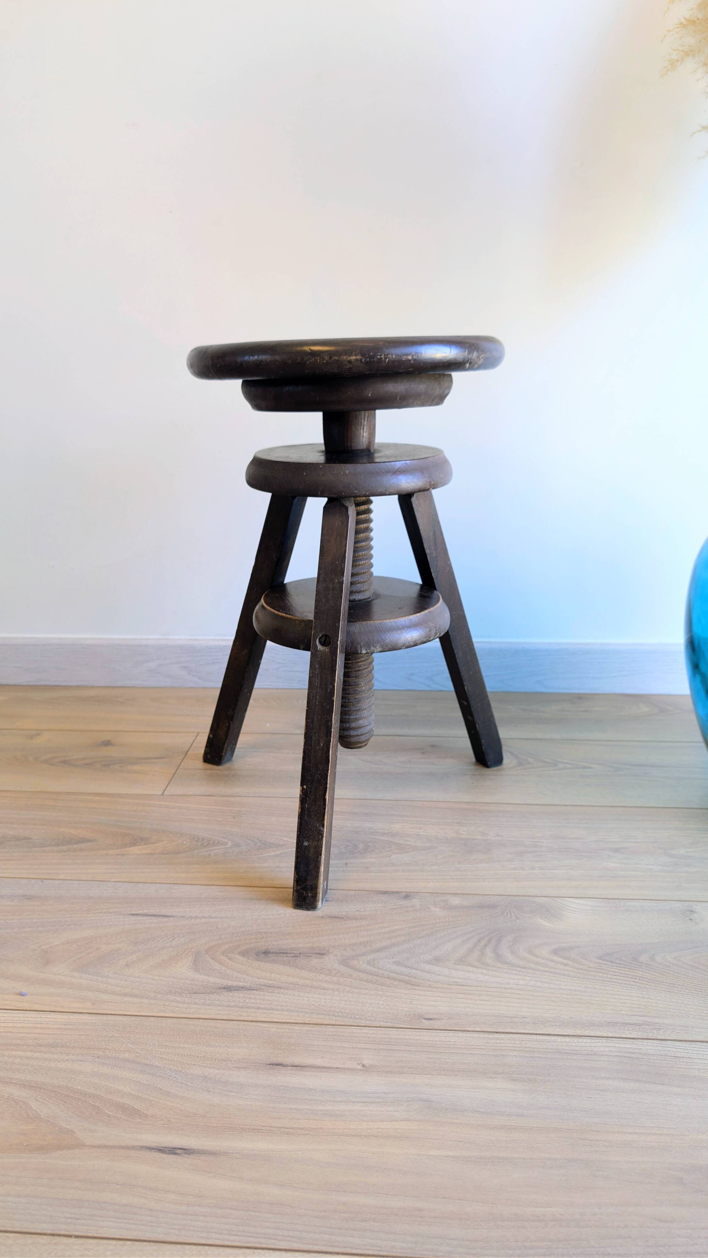Antique wooden watchmaker's stool with screws, patinated wood.