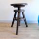 Antique wooden watchmaker's stool with screws, patinated wood.