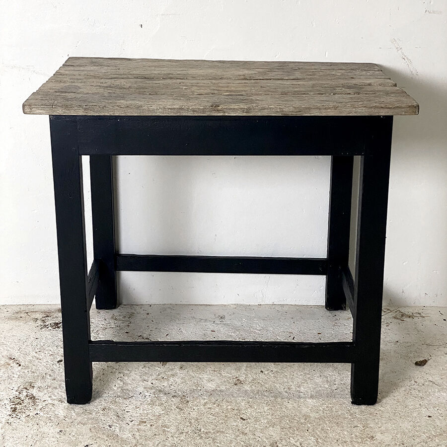 Old blackened wood work table and varnished top