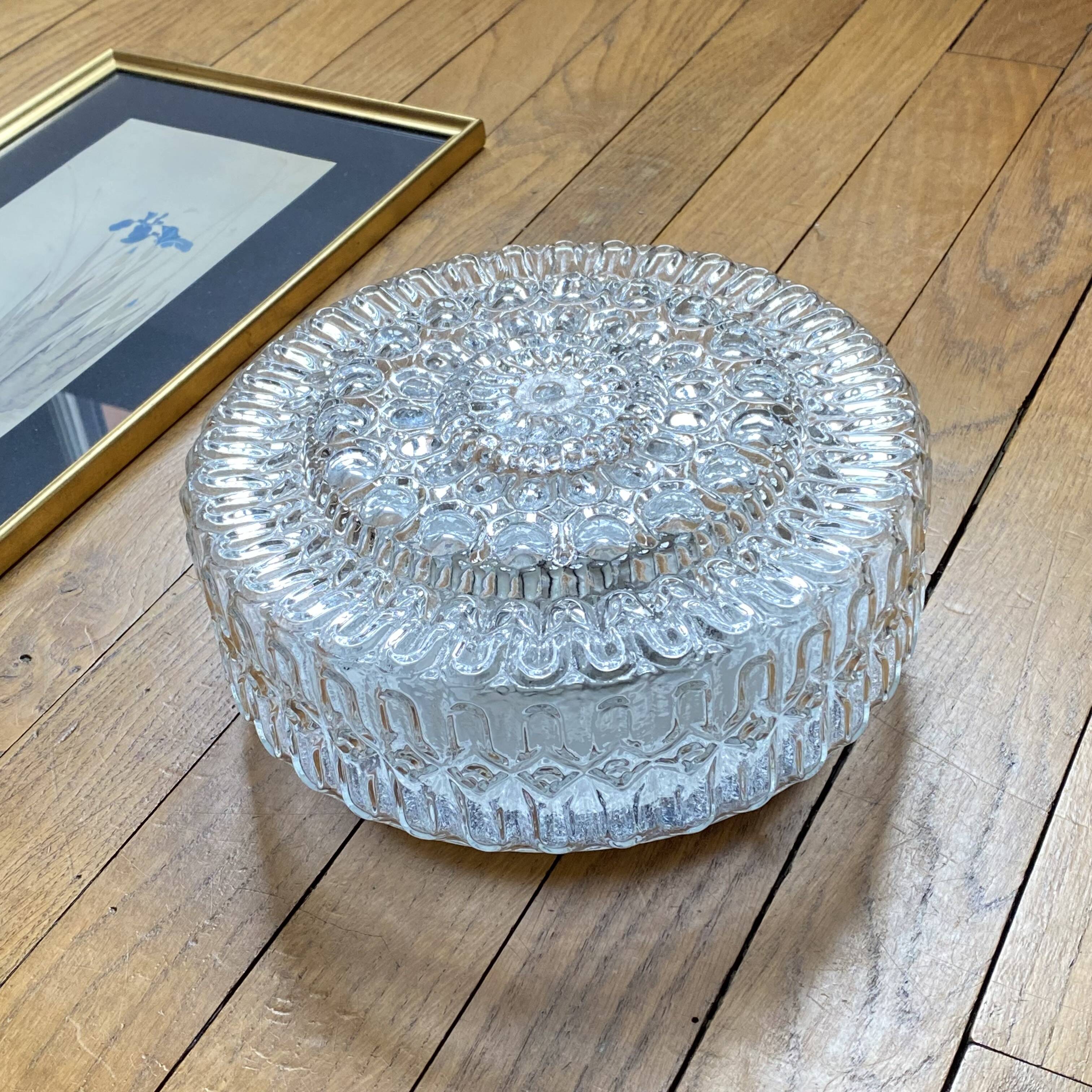 Large wall-mounted ceiling light with transparent glass.