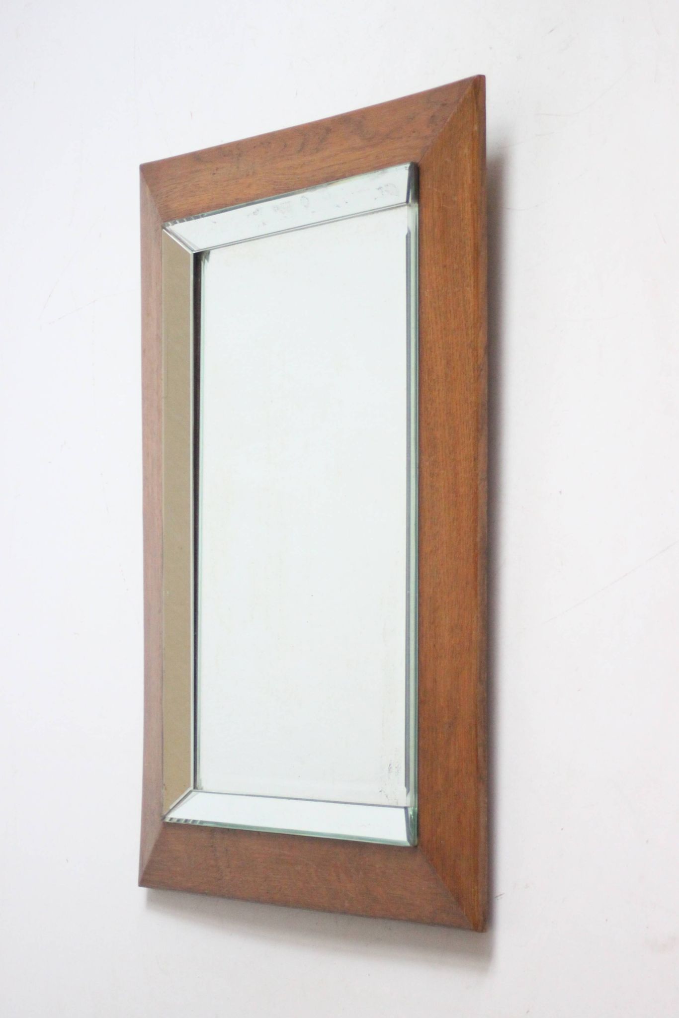 Art deco beveled mirror in an oak frame, 1940s.