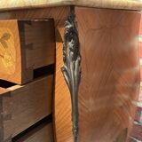 Wooden bedside table topped with a pink marble top