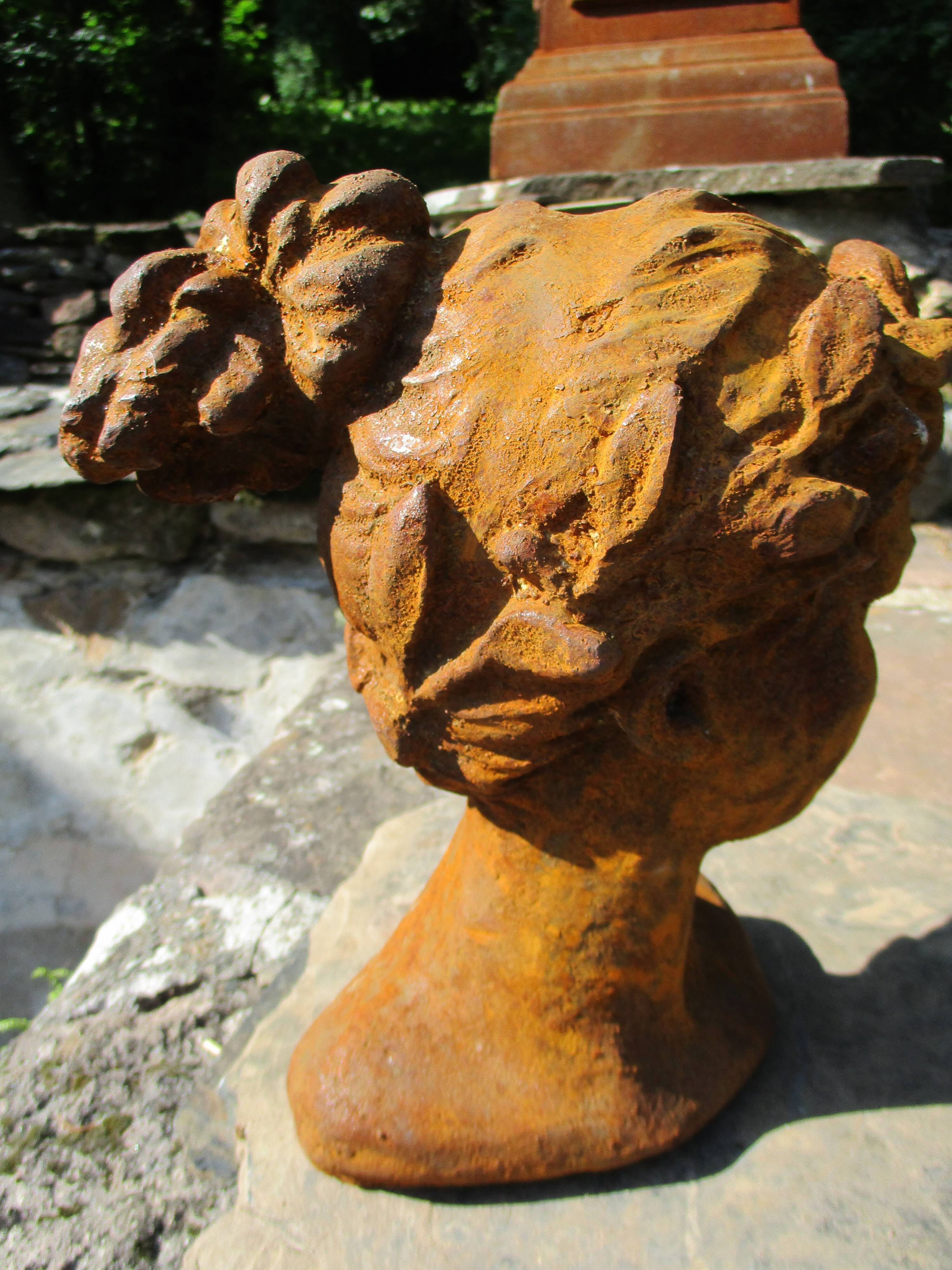 Cast iron sculpture of a woman.