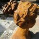 Cast iron sculpture of a woman.