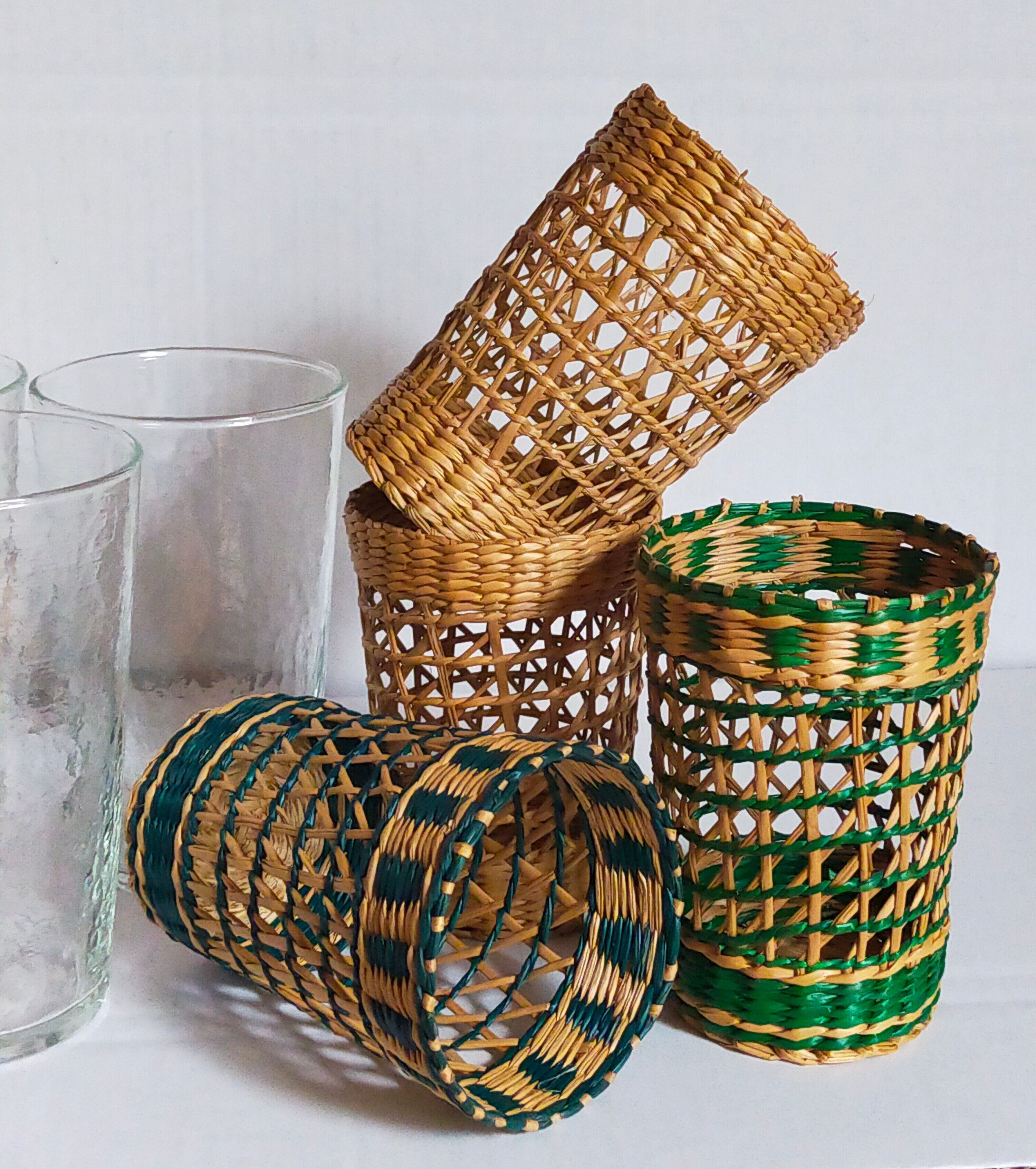 Four long drink glasses in vintage woven rattan cases