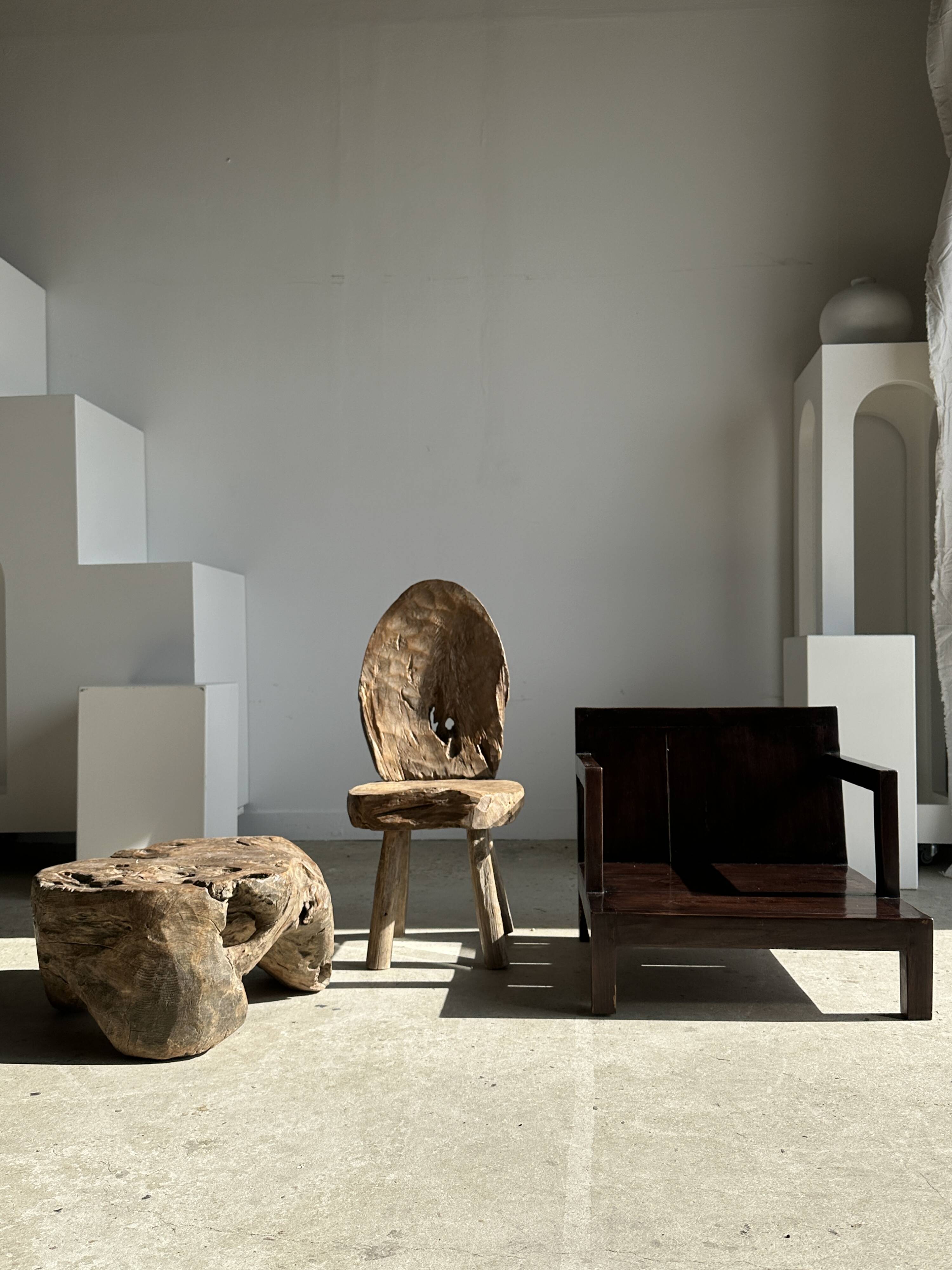 Small low armchair in varnished brown wood