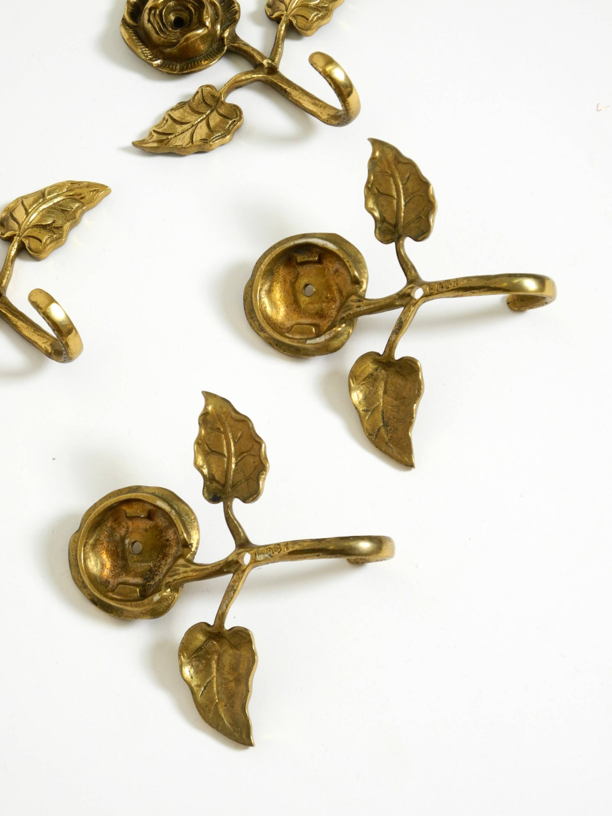 Set of five beautiful, solid mid-century brass rose wall coat hooks