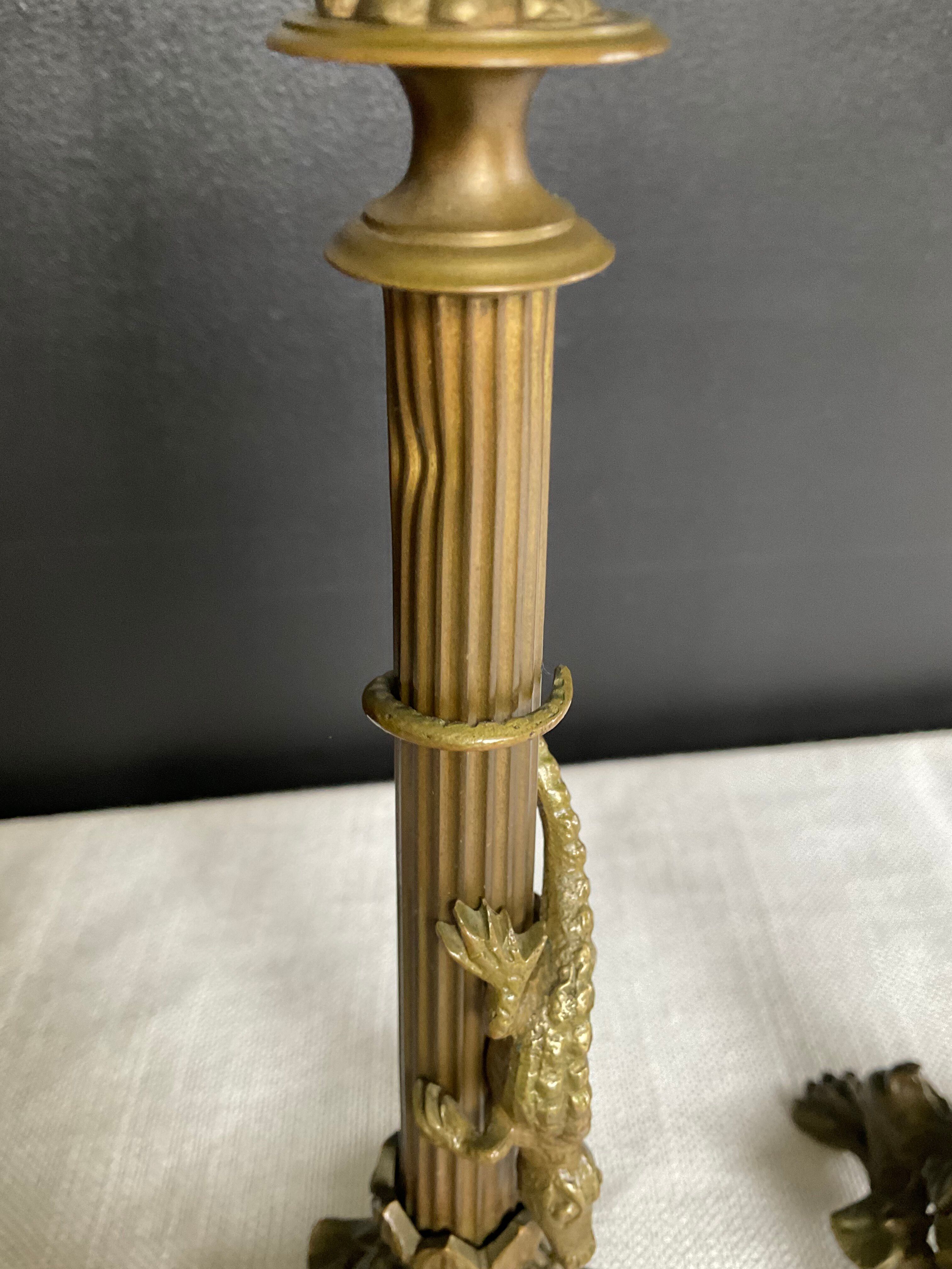 Pair of 19th-century gilded bronze candlesticks in Empire style.