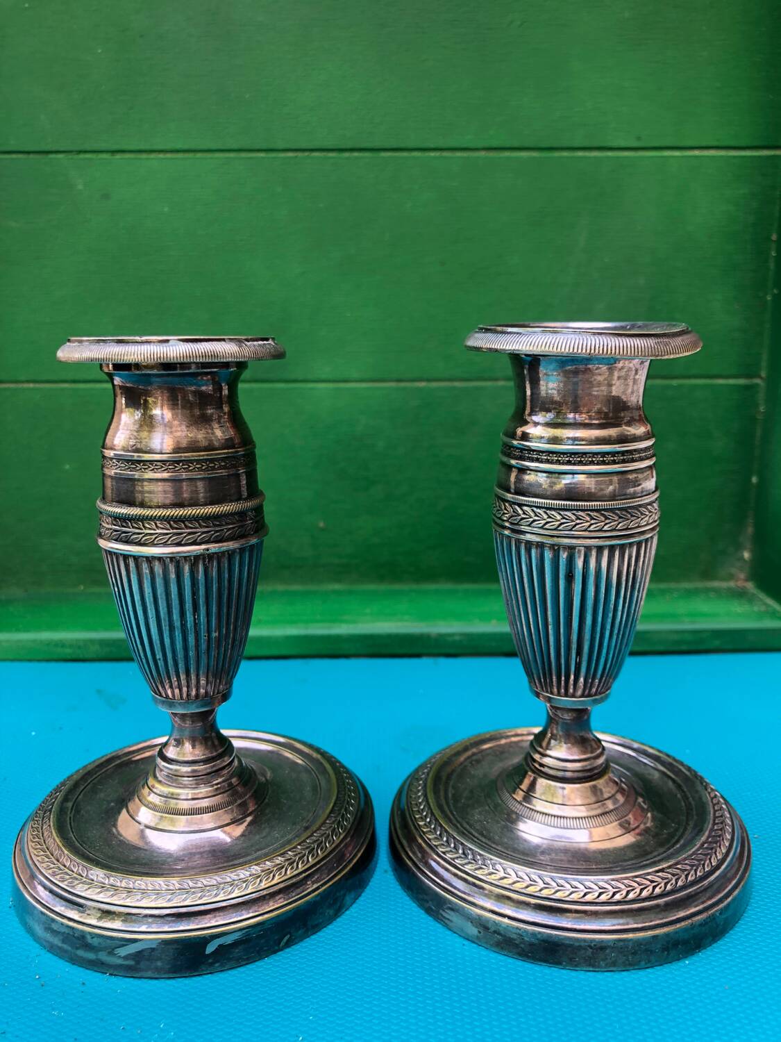 Pair of Louis XVI style candlesticks in silvered bronze