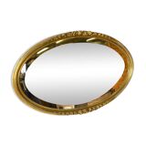 Vintage carved and gilded oval wall mirror