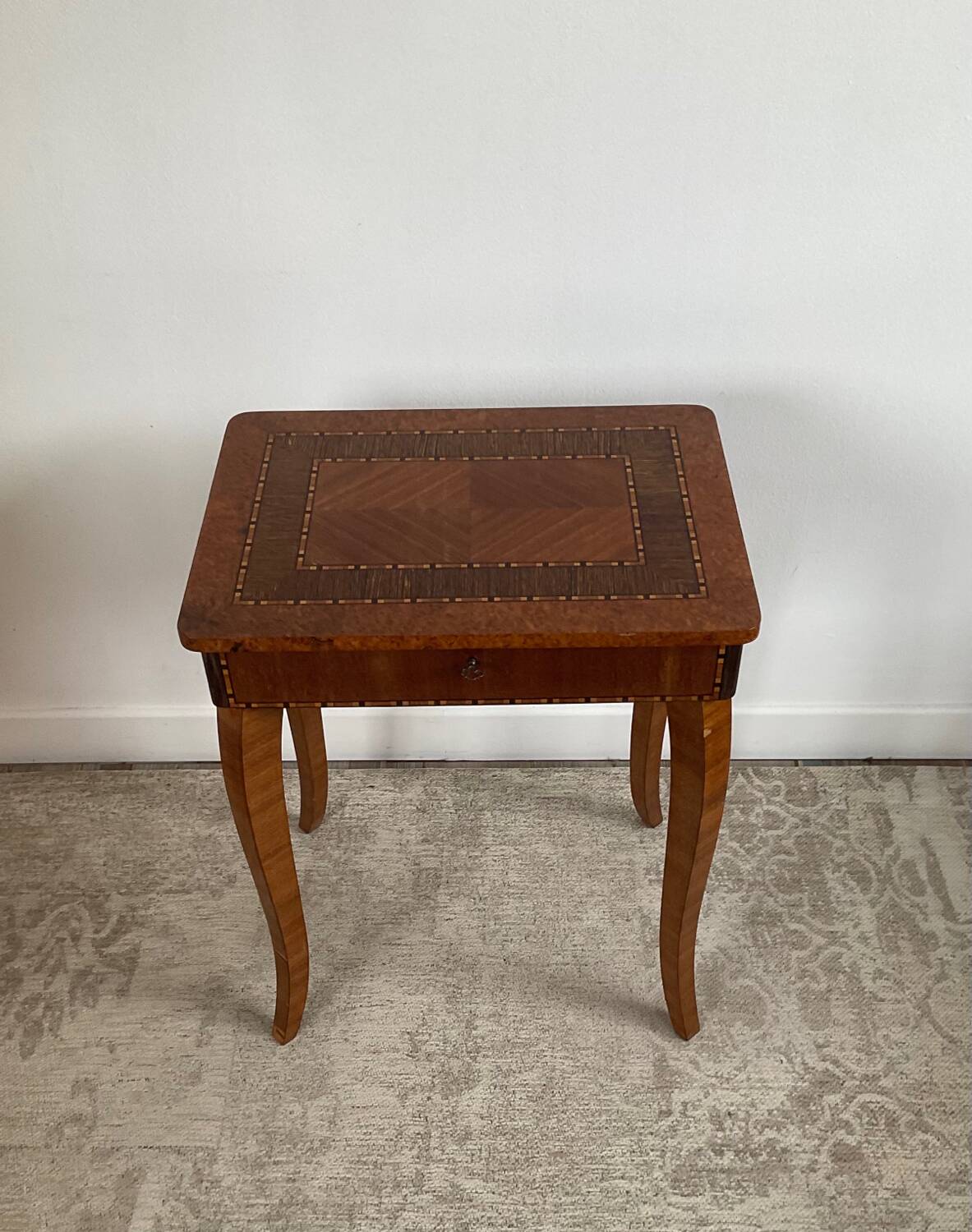 Small marquetry pedestal table with key storage
