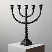 Candelabrum in the shape of a spool, skilfully forged in menorah style.