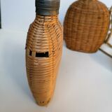 Trio of woven wicker bottles