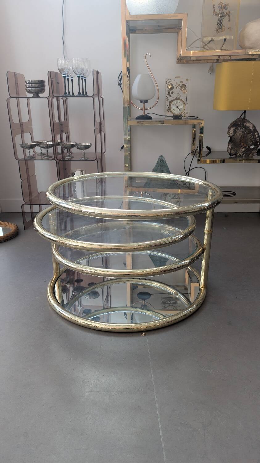 Gold brass coffee table with rotating trays.