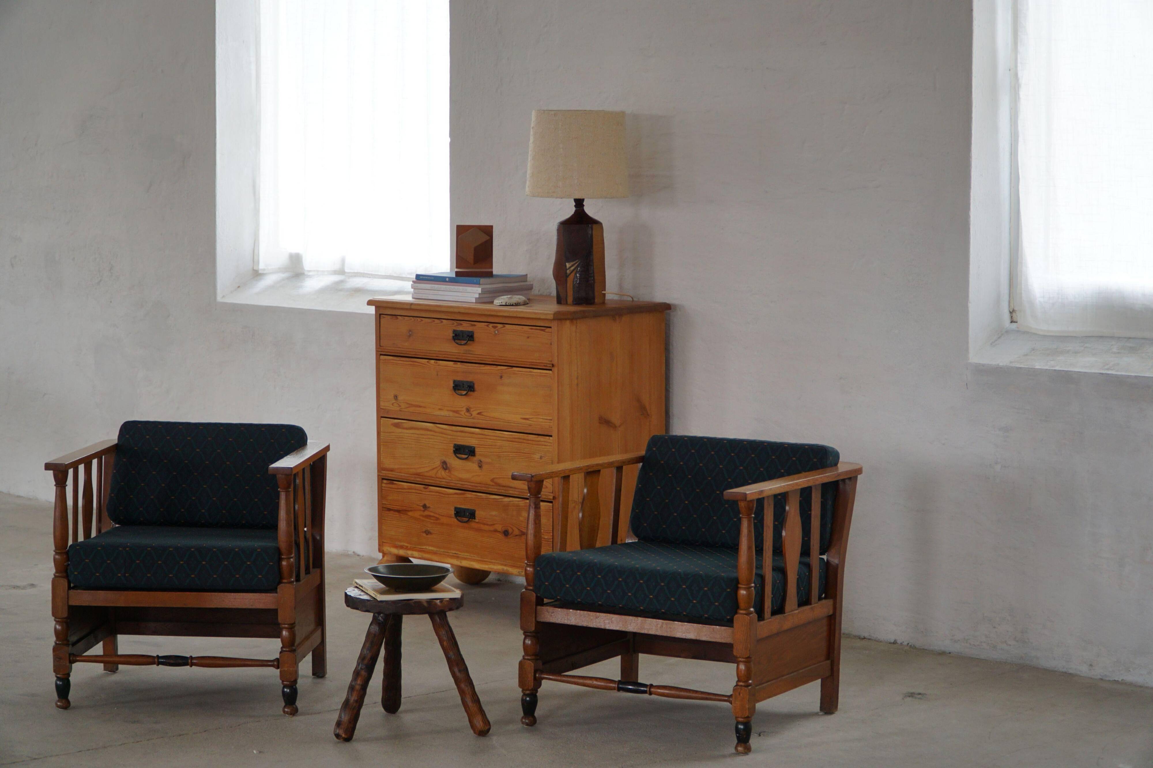 Art Nouveau, pair of oak lounge chairs, reupholstered in style fabric, 1920s.