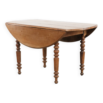 Antique English drop-leaf dining table made of walnut with elegant legs