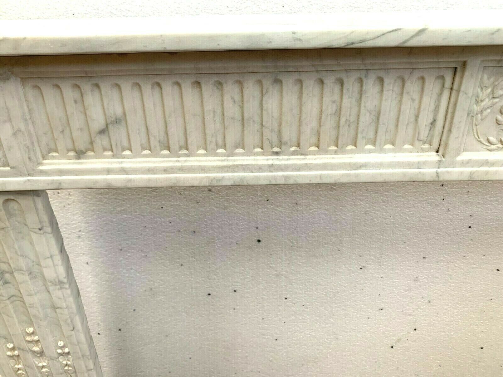Louis XVI fireplace in 19th century white Carrara marble