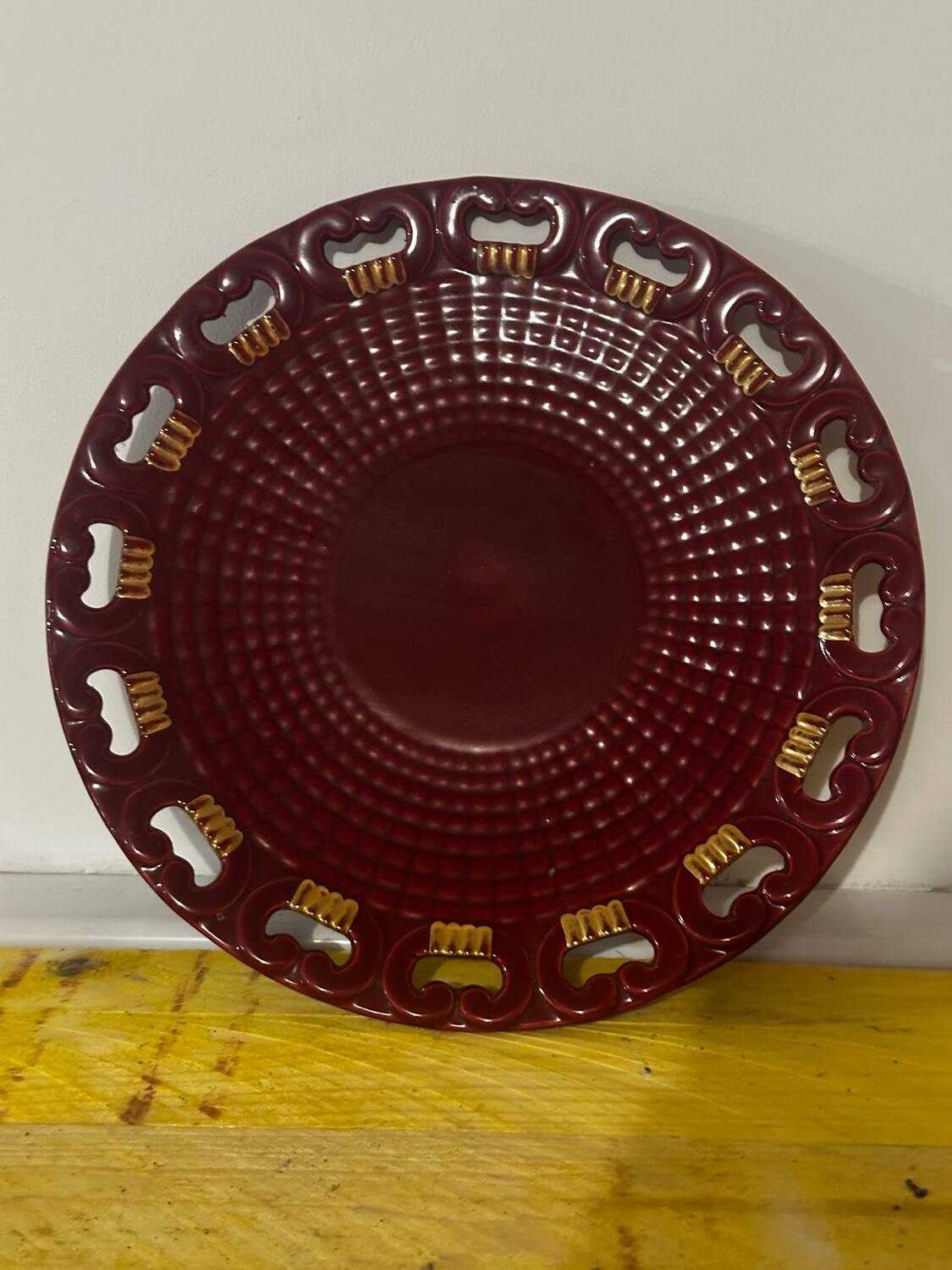 Burgundy and gold openwork plate in ceramic from Saint-Clement, 1950s.