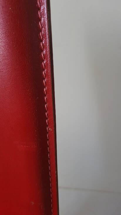 Red leather dining chairs by Arper