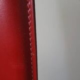 Red leather dining chairs by Arper