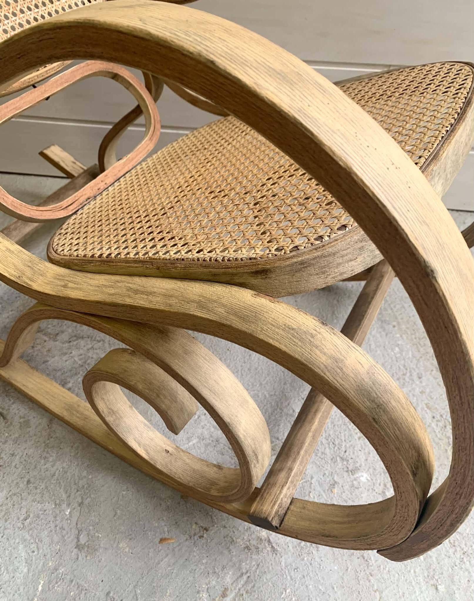 Rocking chair with a cane seat and backrest.