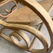 Rocking chair with a cane seat and backrest.