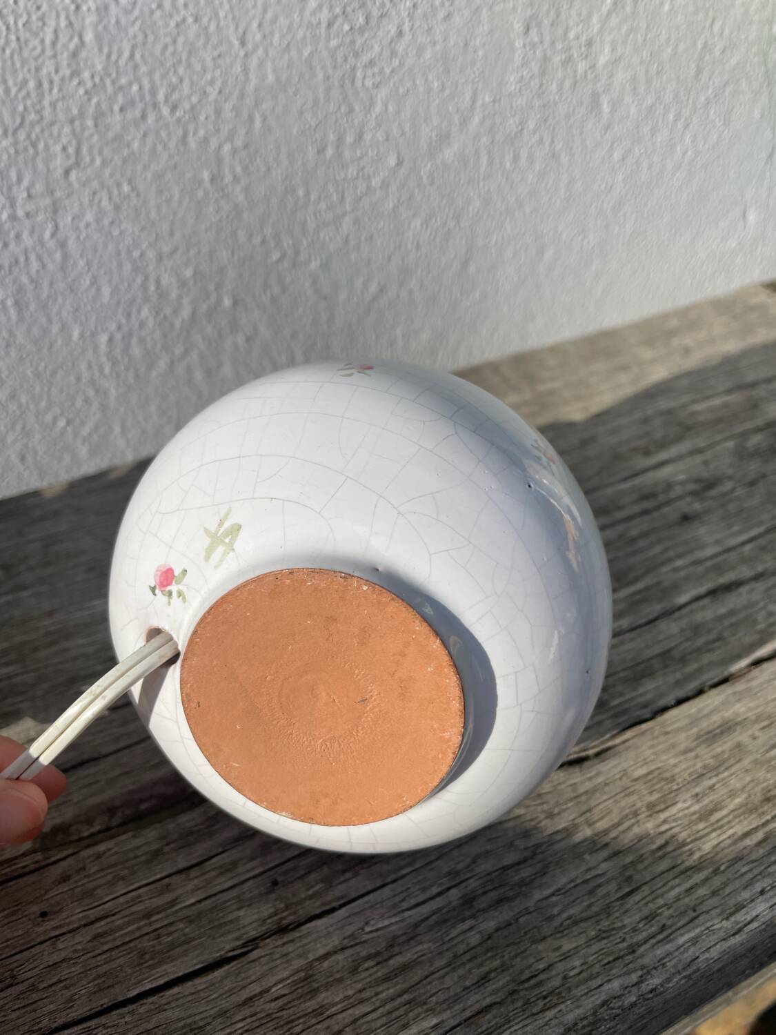 Small cracked white ceramic lamp with flowers.