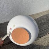 Small cracked white ceramic lamp with flowers.