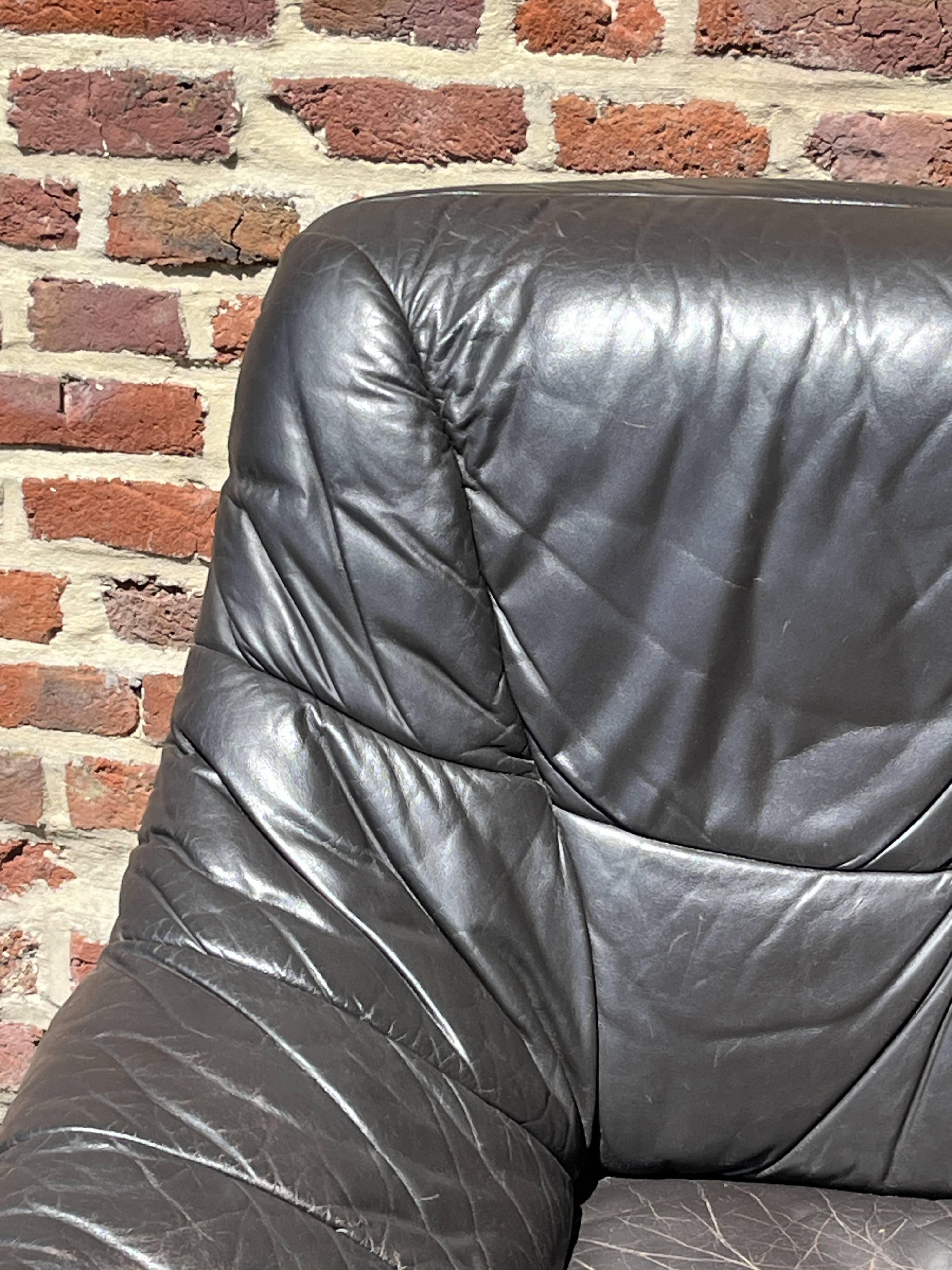 Pair of patinated leather club armchairs