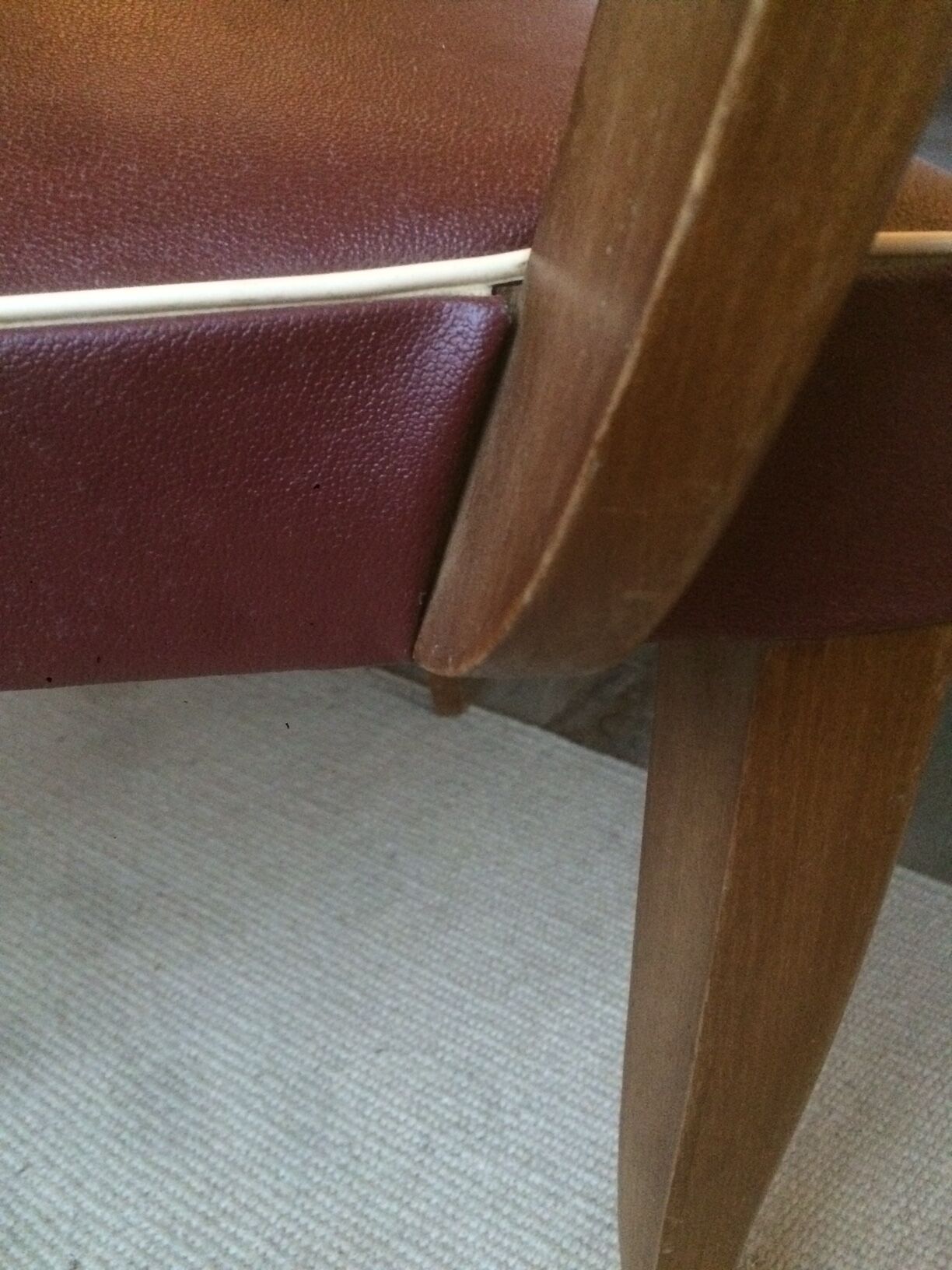 Skai chair binds wine and wooden footpieces and armrests