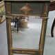 Empire-style mirror in deep green lacquered wood richly enhanced.