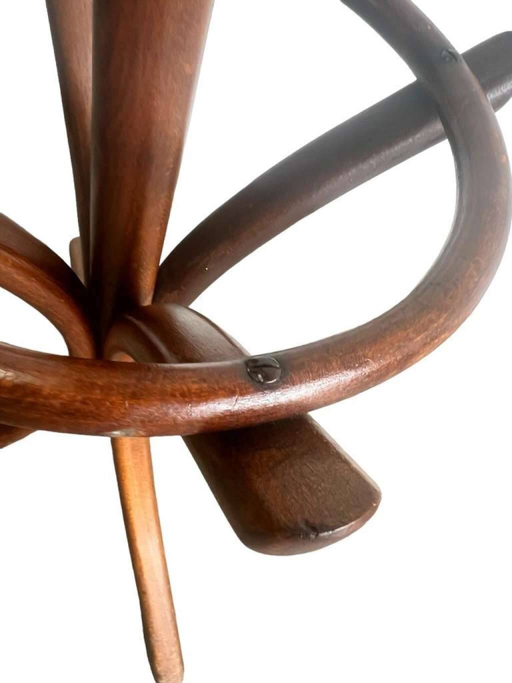 Vintage coat rack on floor in curved wood, thonet style