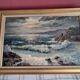 Large old oil painting depicting a seascape.