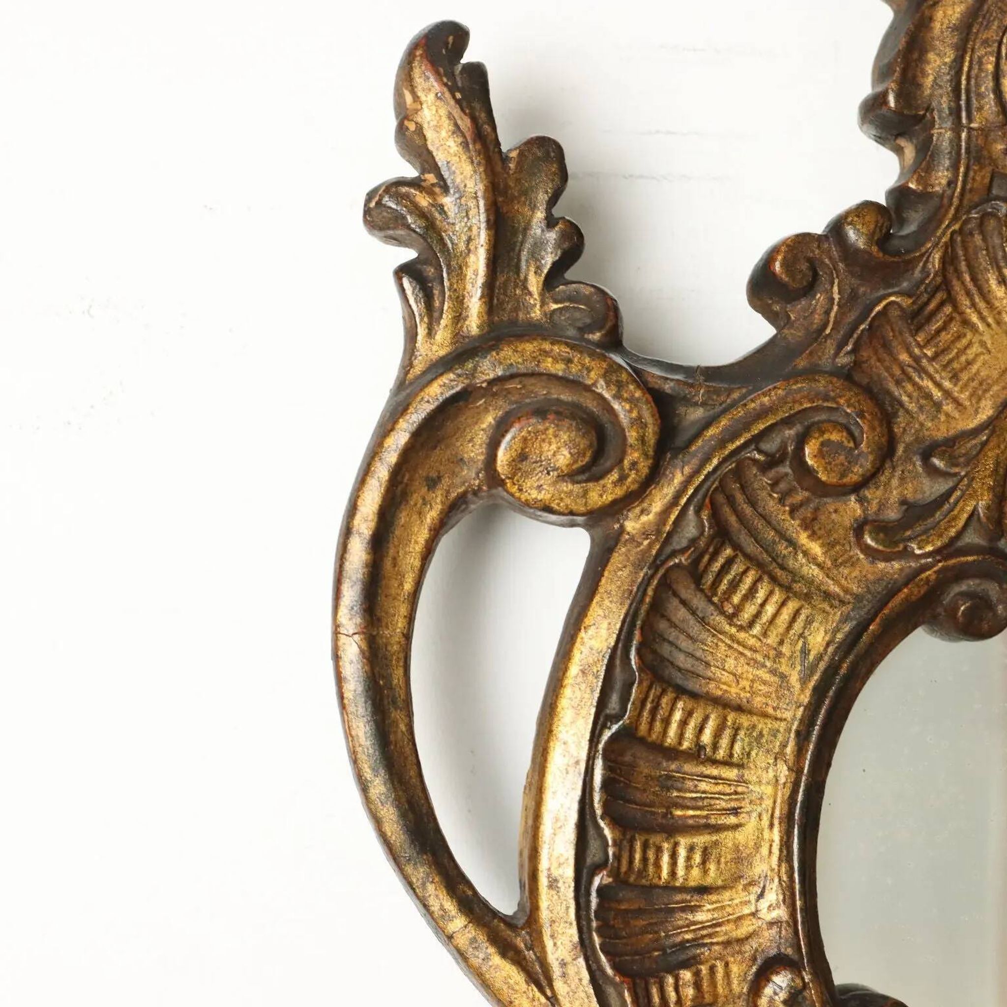 Antique Rococo-style mirror, gilded linden decorations, 20th century.