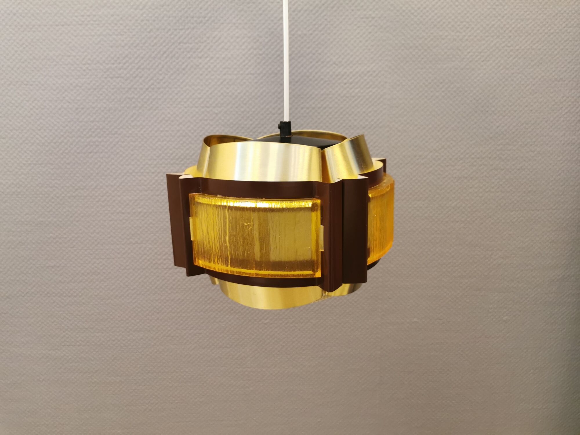 Danish hanging lamp, made in brass colored and brown metal, with yellowish hard pressed plastic deta
