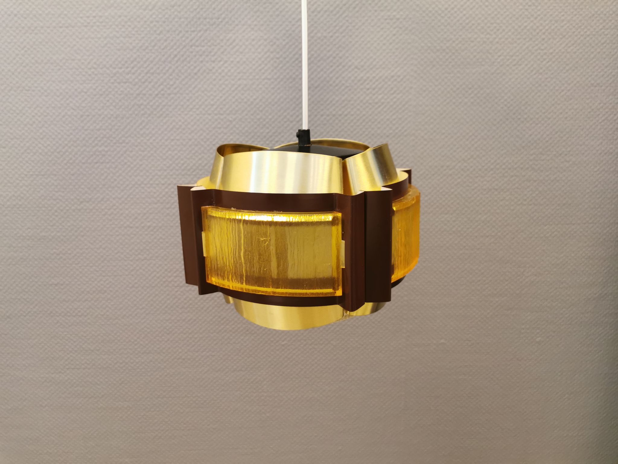 Danish hanging lamp, made in brass colored and brown metal, with yellowish hard pressed plastic deta