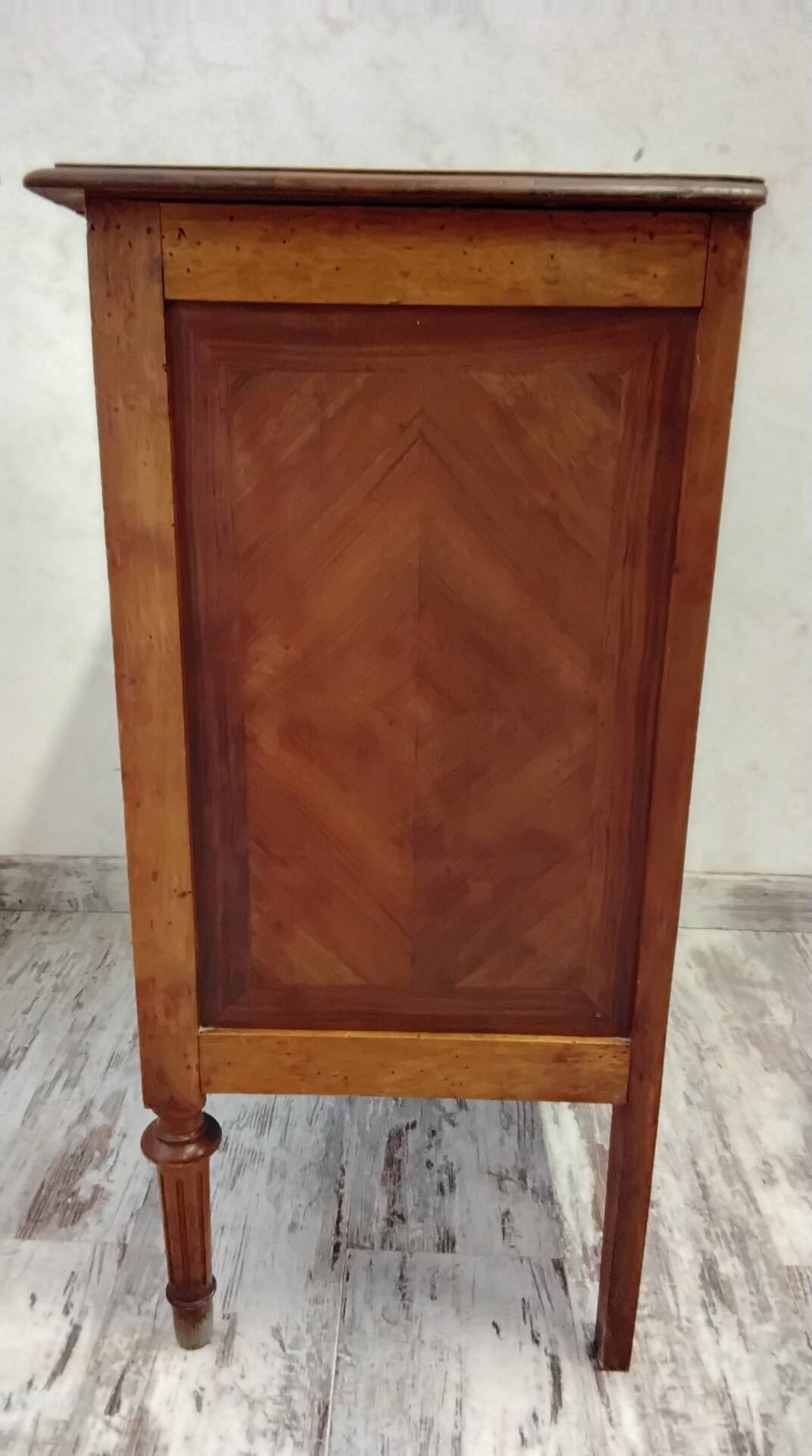 Antique marquetry commode in the Louis XVI style.