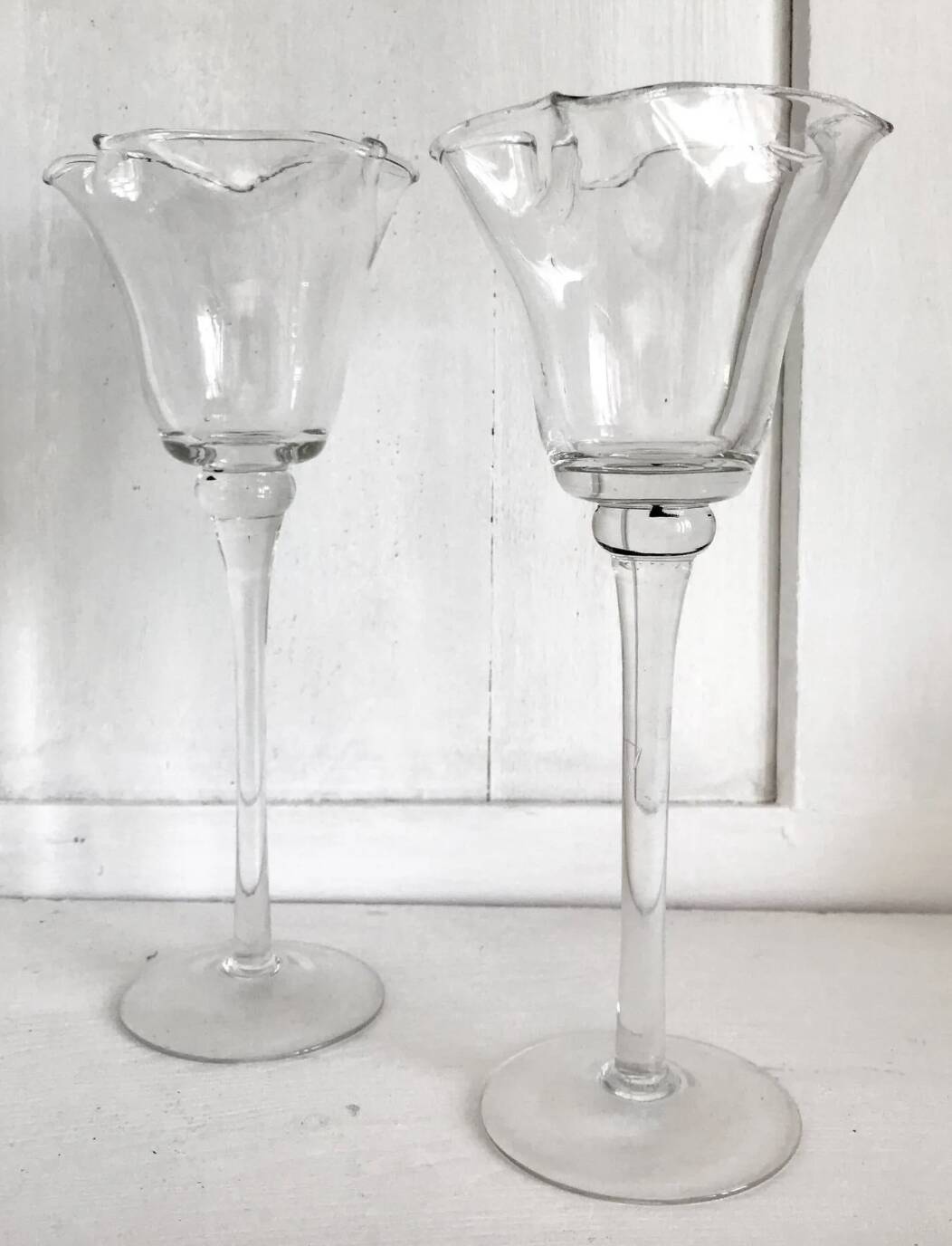 Pair of glass candlesticks on a stand
