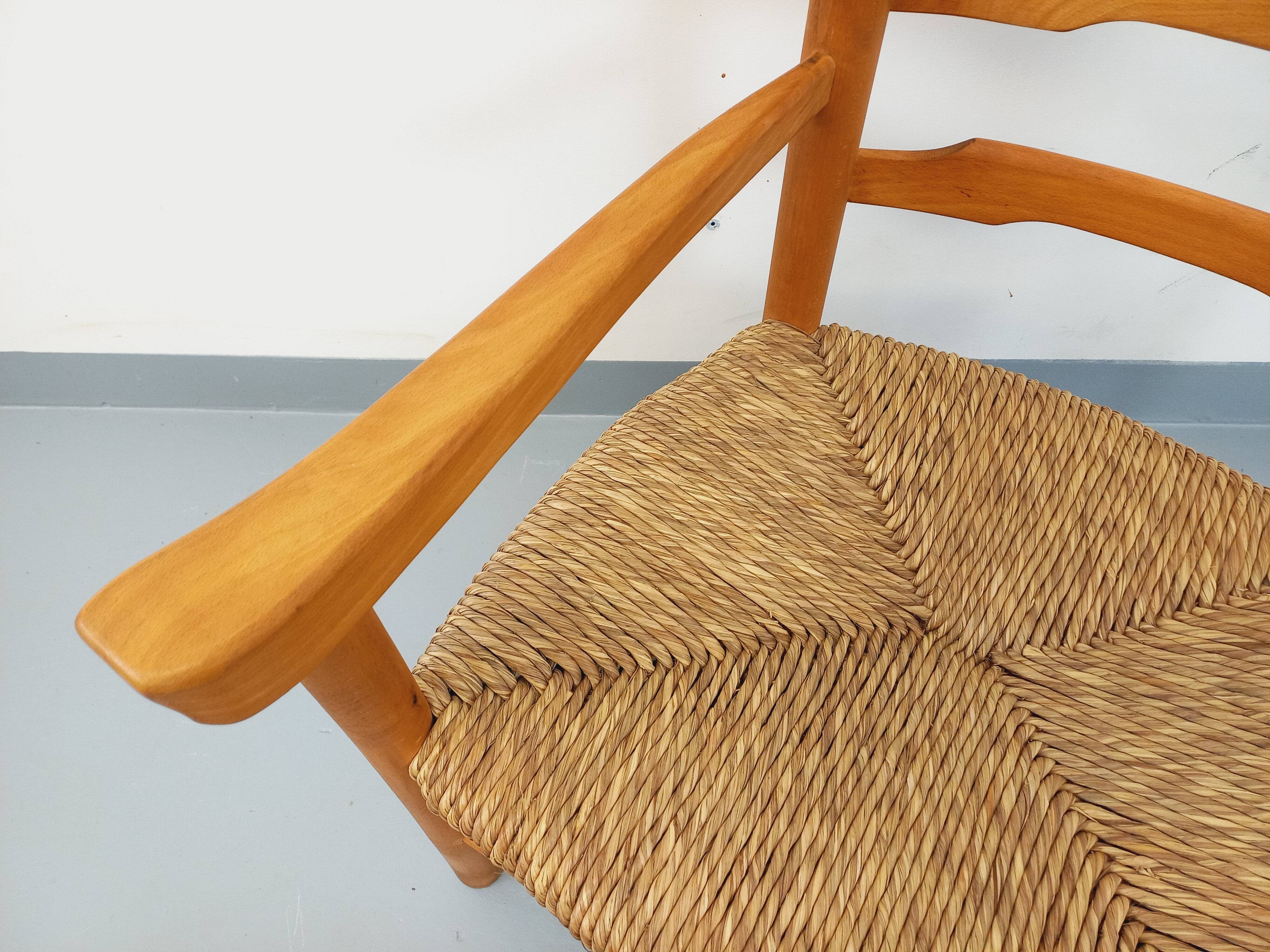Vintage armchair in beech wood and straw from the 1950s.