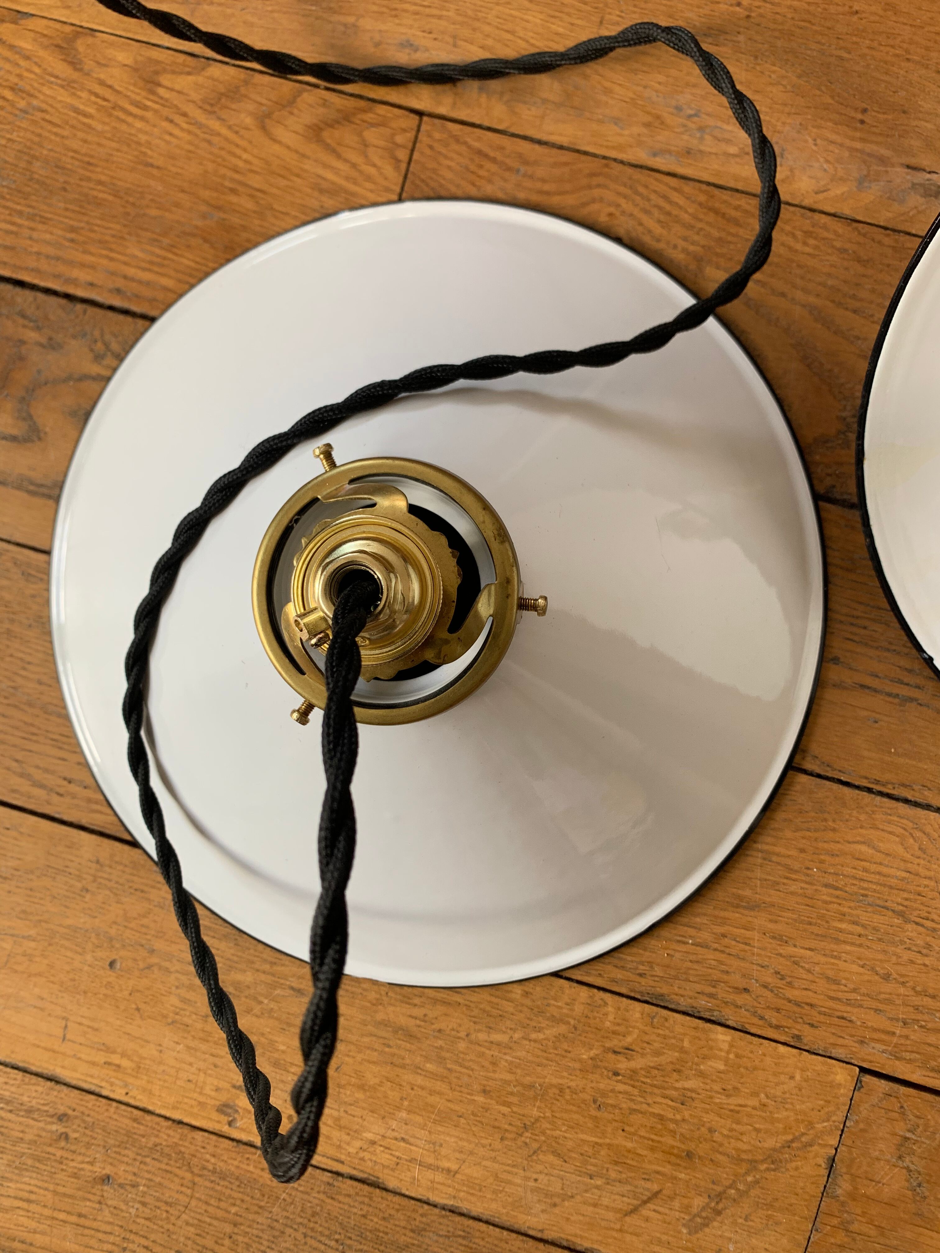 Old pair of white industrial metal suspensions with black border