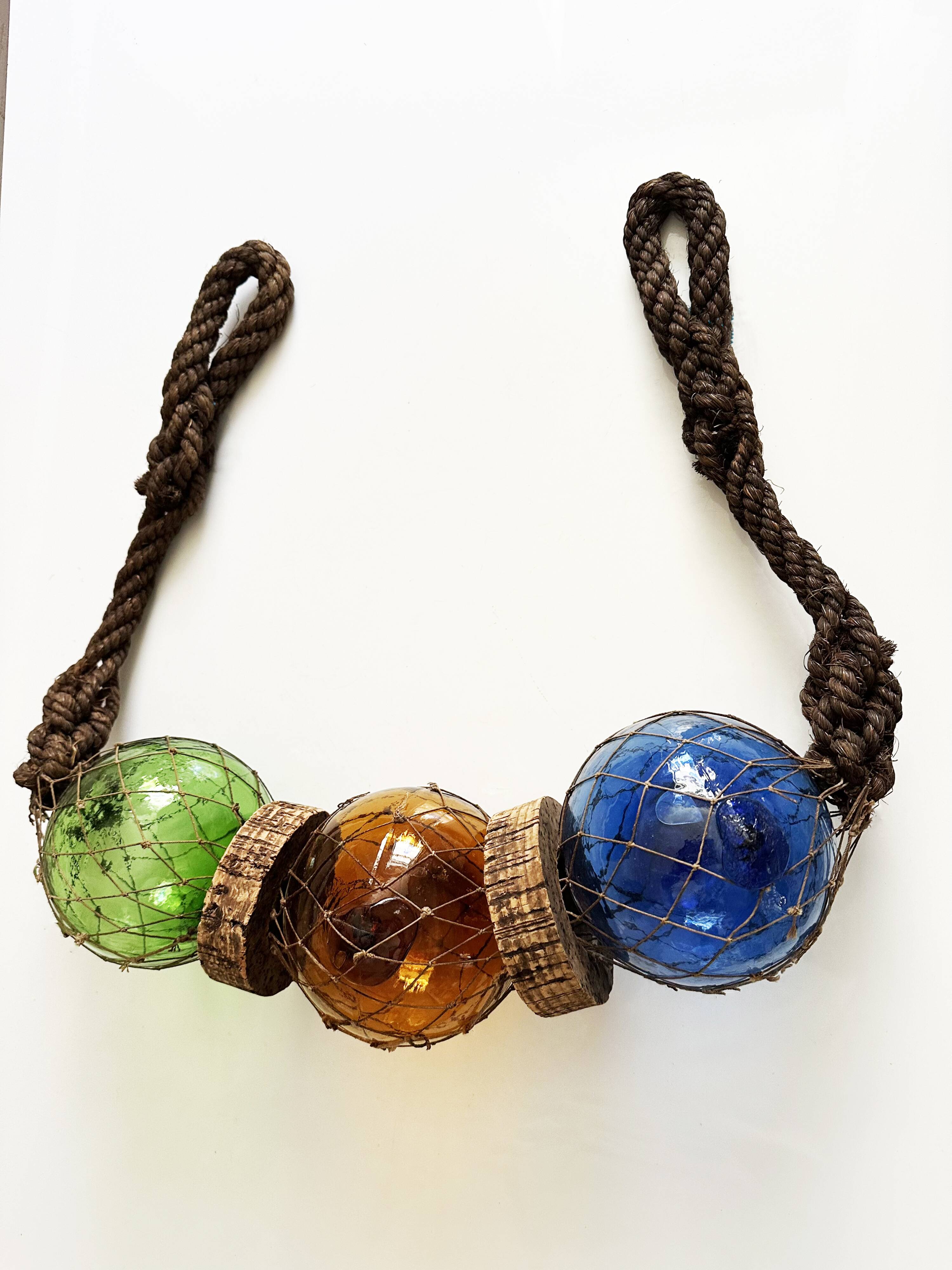 Fishing floats made of blown glass, cork, and rope. France, 1960s.
