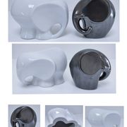 Two iridescent black and white ceramic elephants design