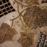 Empty pocket in openwork copper, chiseled and painted vine branches