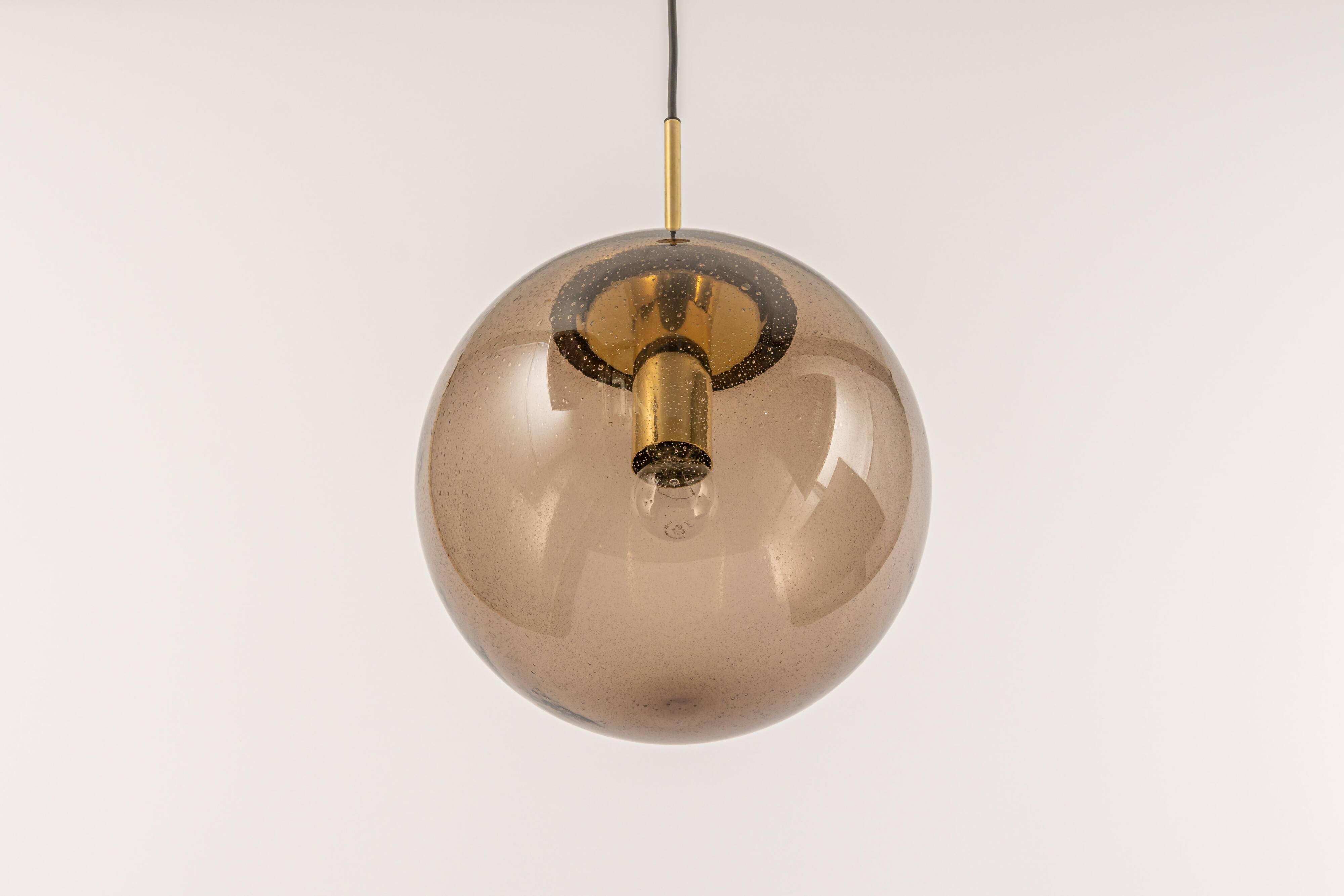 Large smoked glass ball pendant by Limburg in brass, Germany, 1970s.