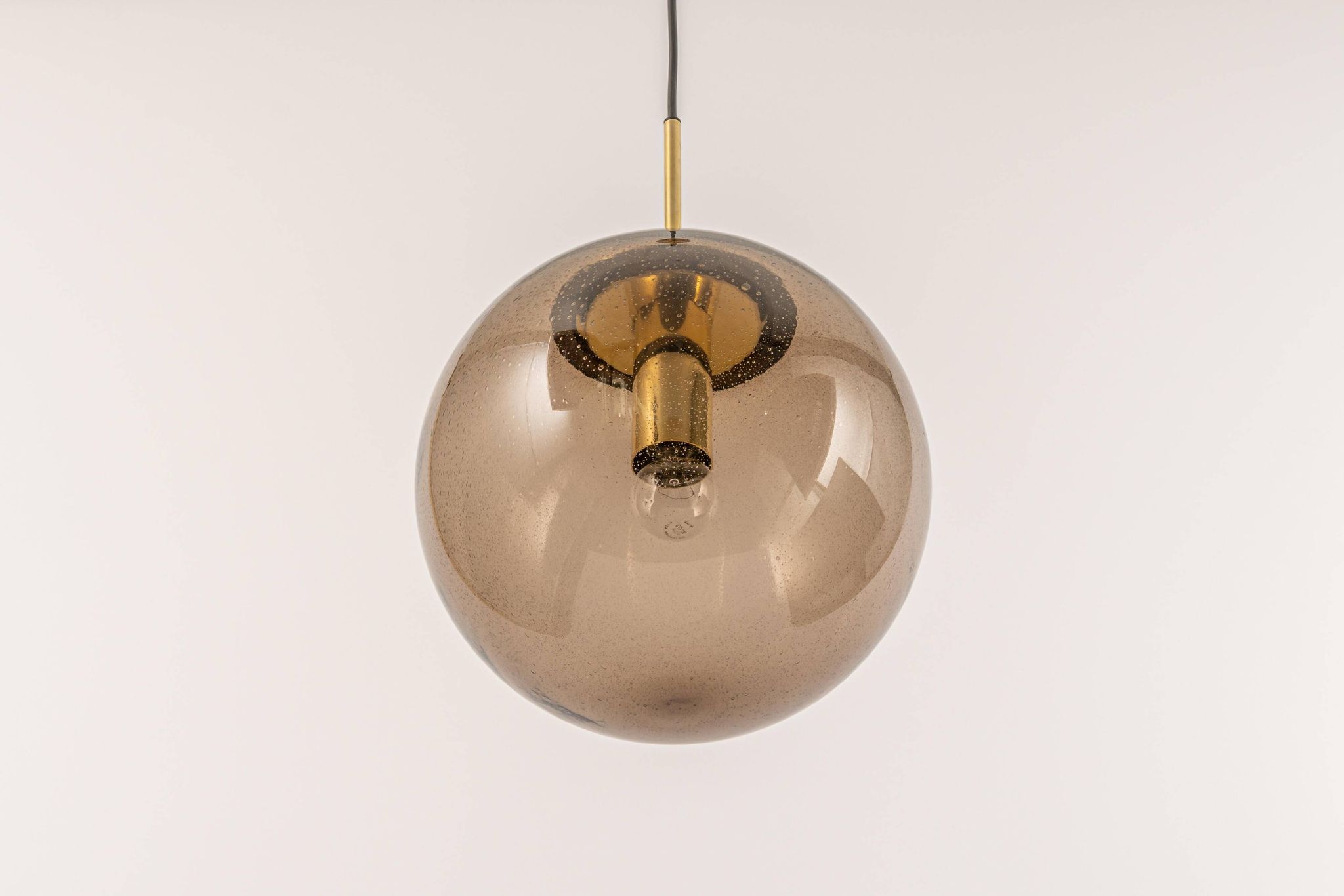Large smoked glass ball pendant by Limburg in brass, Germany, 1970s.