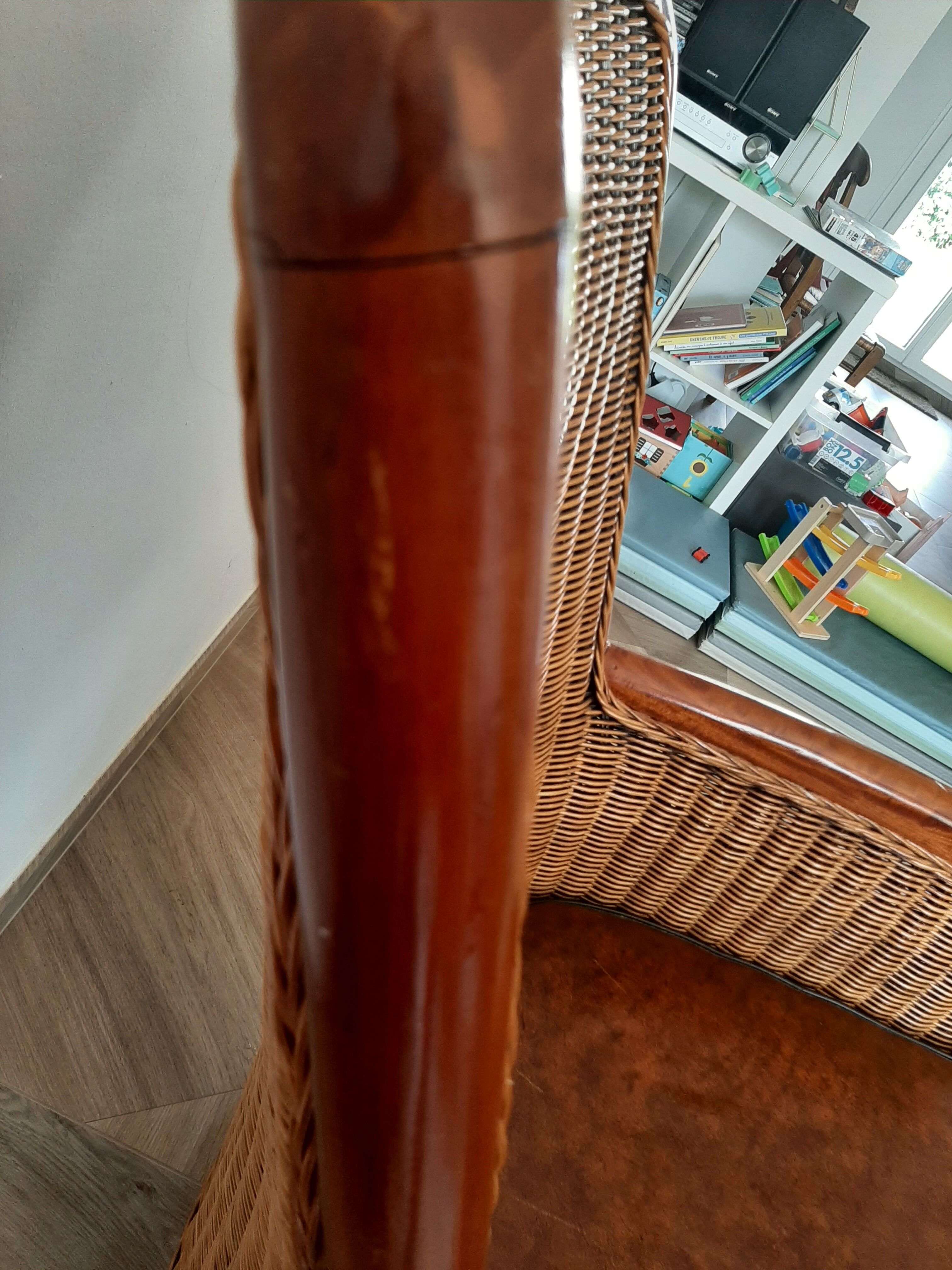 Armchair in woven rattan and exotic wood