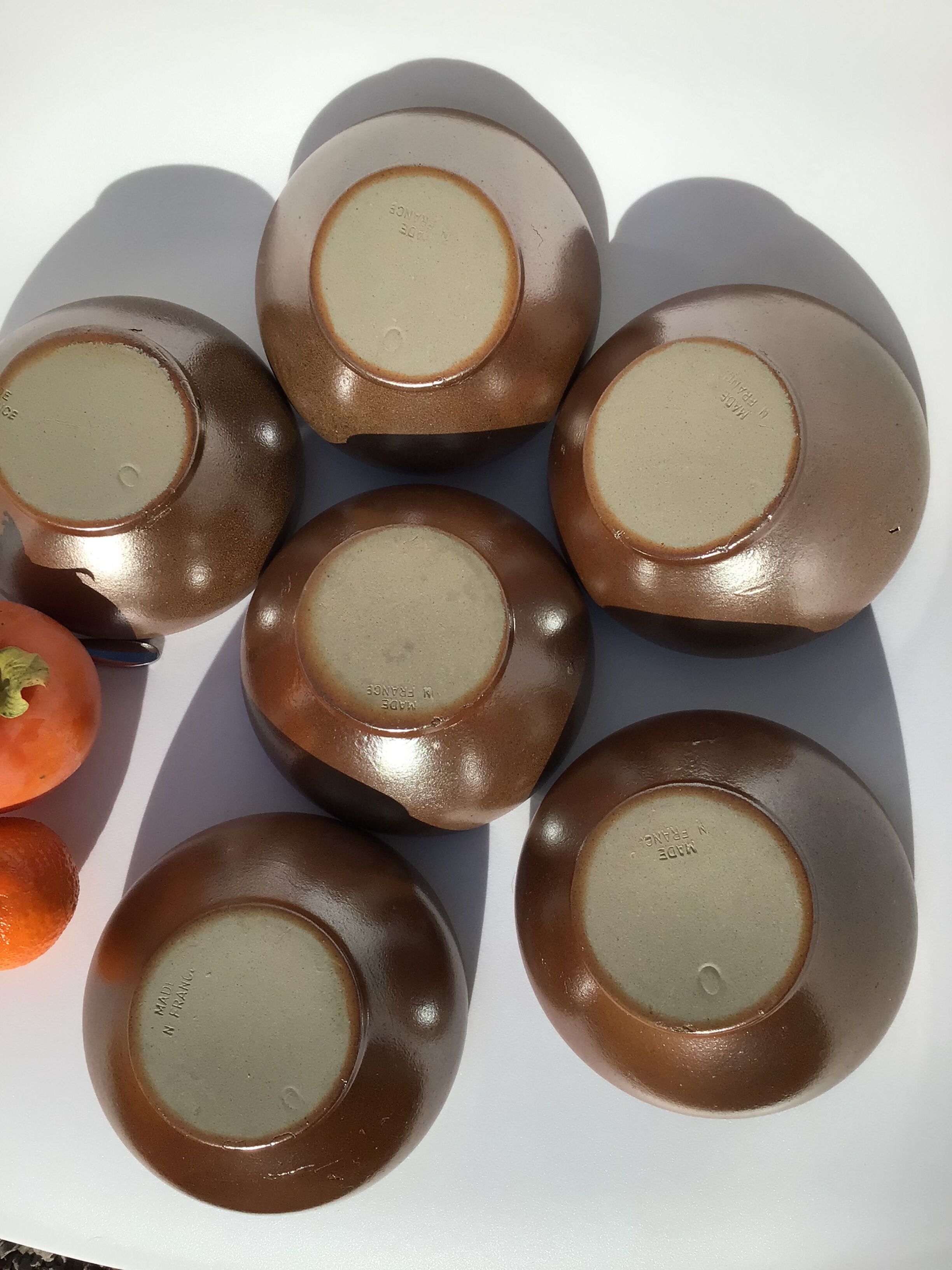 6 iridescent brown sandstone bowls inside grey