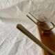 Vintage wooden wall-mounted coat rack with 3 golden cast aluminum hooks