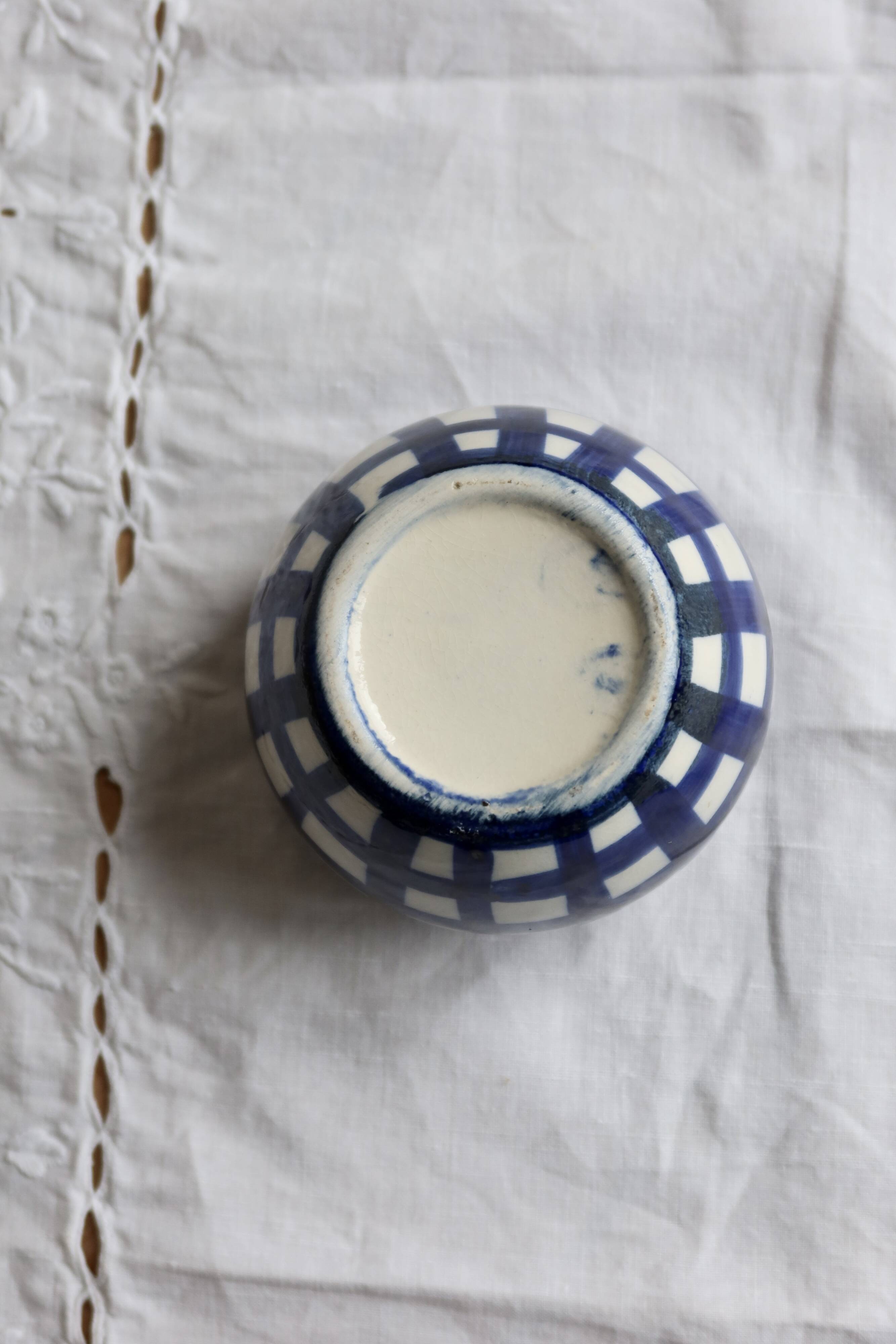 Vintage ceramic cache-pot with navy blue gingham pattern.