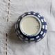 Vintage ceramic cache-pot with navy blue gingham pattern.